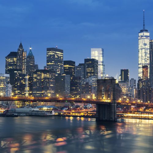 New York City Manhattan midtown at dusk with Brooklyn Bridge. USA.